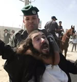 Zionist soldier restrains religious Jew with a choke hold.