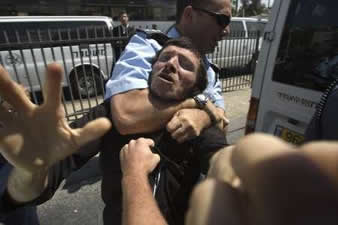 policeman with chokehold on demonstraor